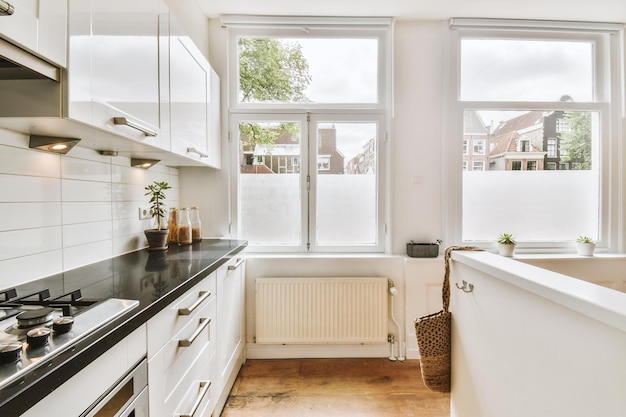 Photo interior of modern kitchen with white furniture