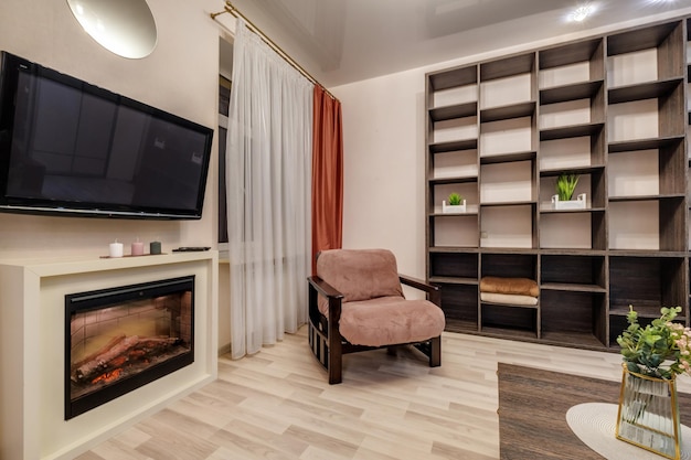 Interior of modern living room with fireplace tv and sofa in\
studio apartments in light pink color style