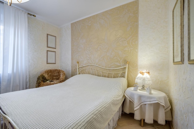 Интерьер современной роскошной спальни с подушками на кровати в квартирах-студиях в светлом стиле
