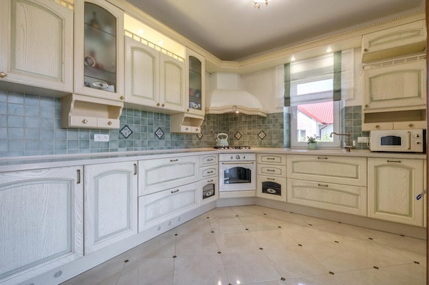 Interior of the modern luxure kitchen in studio apartments with light color