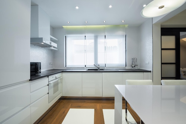 Interior of a modern luxury bright white kitchen