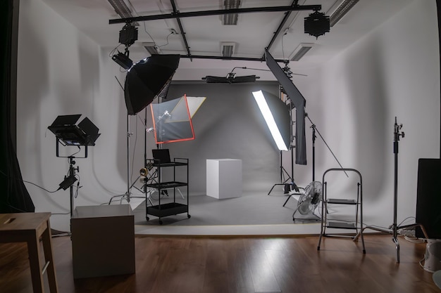 Interior of modern photo studio with octaboxes and professional photo camera on tripod against black