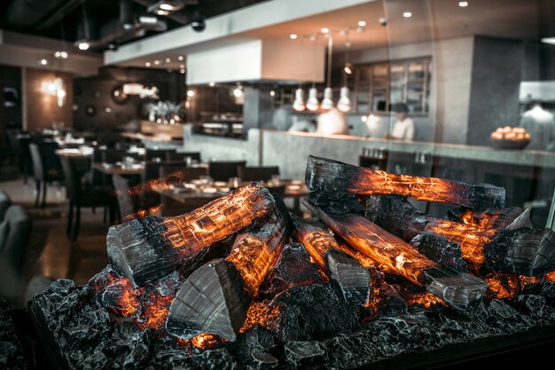 Interior of modern restaurant with fireplace close-up