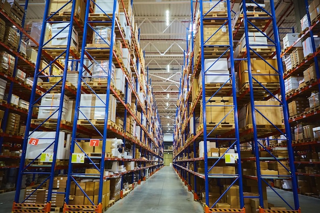 Interior of a modern warehouse storage of retail shop with pallet truck near shelves