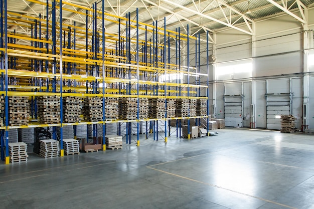 Interior of a modern warehouse storage of retail shop with pallet truck near shelves