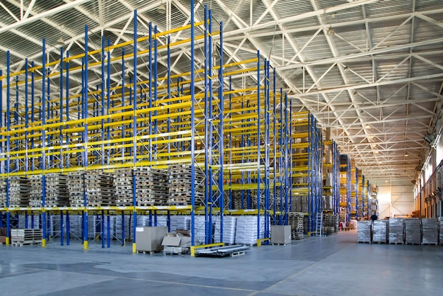 Interior of a modern warehouse storage of retail shop with\
pallet truck near shelves