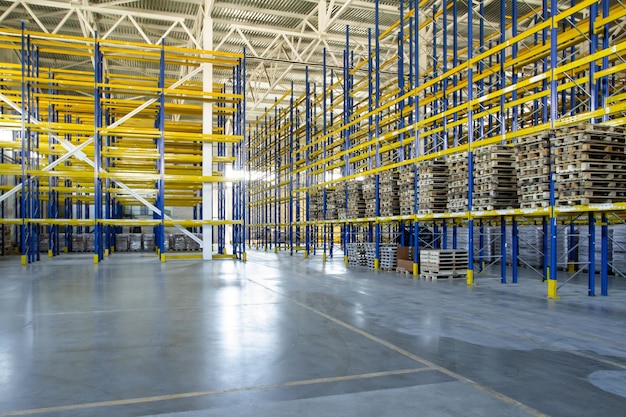 Interior of a modern warehouse storage of retail shop with\
pallet truck near shelves