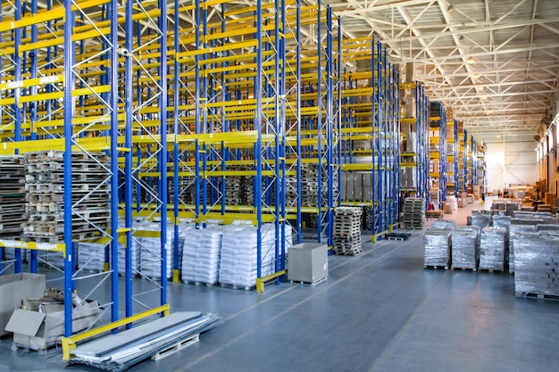 Interior of a modern warehouse storage of retail shop with pallet truck near shelves