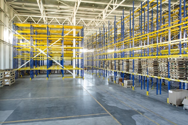 Interior of a modern warehouse storage of retail shop with pallet truck near shelves