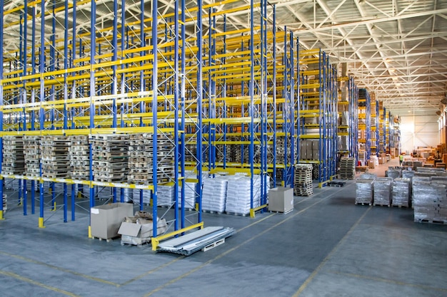 Interior of a modern warehouse storage of retail shop with pallet truck near shelves