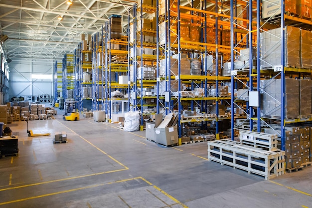 Interior of a modern warehouse storage of retail shop with\
pallet truck near shelves