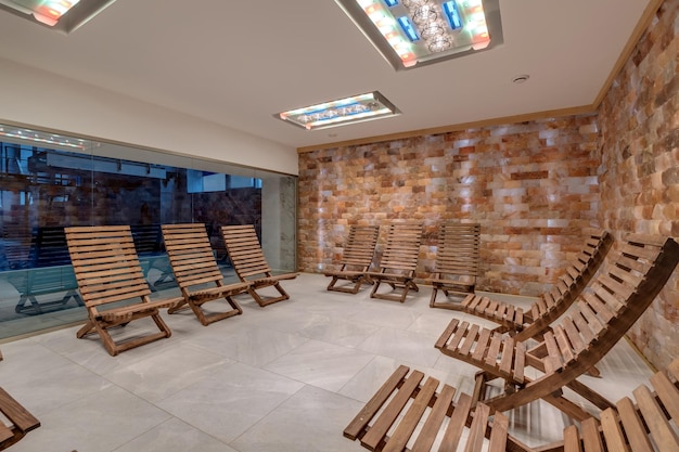 Interior of modern wellness salt haloper cave with uv light with wooden bench