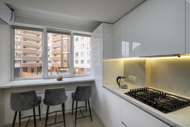 Interior of a modern white kitchen in a luxury studio apartmen