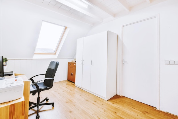 Interior of a modern workplace at home and white walls. window in the background