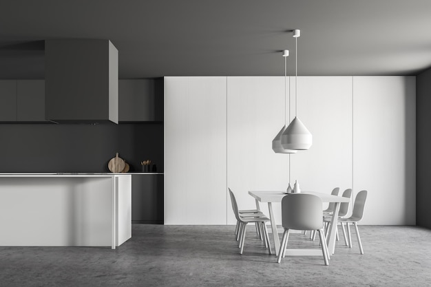 Фото Интерьер стильной кухни с серыми стенами, каменным полом, серыми столешницами, белым шкафом, белым островом и длинным белым столом со стульями. 3d визуализация