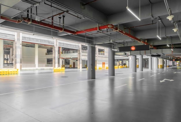 interior of parking garage with car and vacant parking lot in parking building