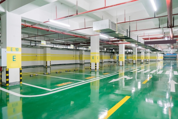 interior of parking garage with car and vacant parking lot in parking building