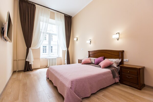 Interior photo of a bedroom with a large bed