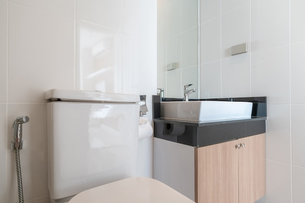 Interior real bathroom features basin, toilet bowl