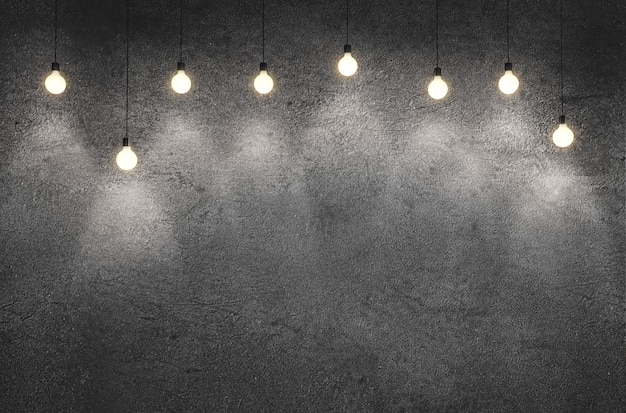 Photo interior room with dirty concrete cement wall with hanging lightbulbs.