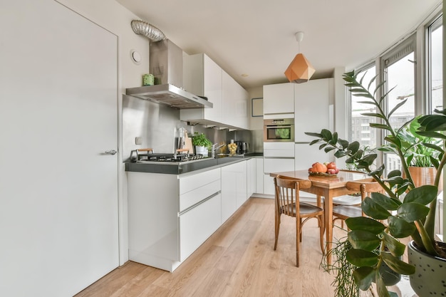 Interior shot of a dining table next to a kitchen in a nice house