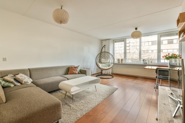 The interior of a spacious living room with a corner dvin opposite the TV