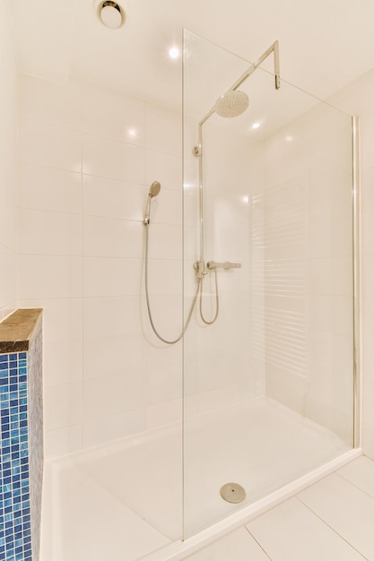 The interior of a spacious modern bathroom in a cozy residential apartment with a glazed shower cabin