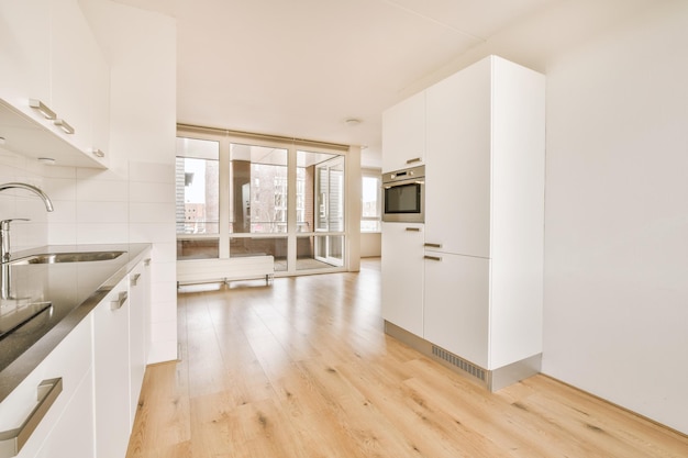 Interior of a spacious wellequipped kitchen in light colors in a modern house