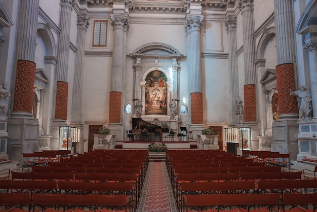 Photo interior of unadorned church with red chairs in birds eye view