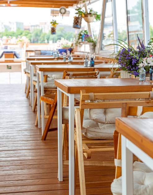 The interior of the urban river ship, with a panoramic view of the urban landscape. The concept of tourism, recreation, walking around the city, rest in the city. River transport.