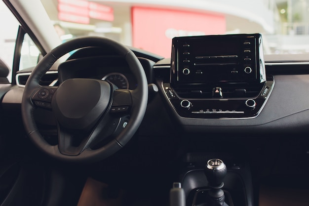 Photo interior view of car with black salon. steering wheel, auto