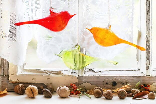 Interior window with glass birds and nuts