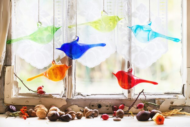 Interior window with glass birds and nuts