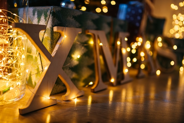 interior with candles, bulbs and bokeh. room decorated to christmas celebration.