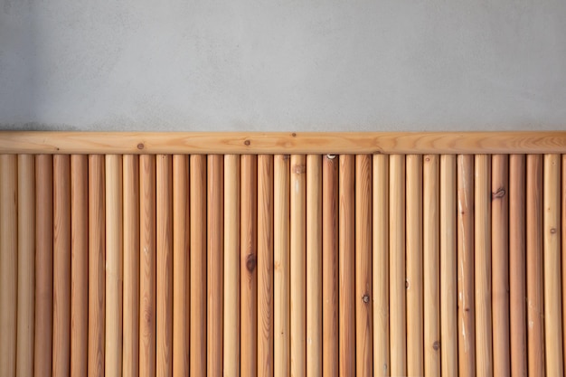 Photo interior with a light wall decorated to the middle with a panel of wooden slats