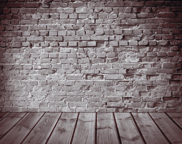 Interior with an old brick wall and wooden floor