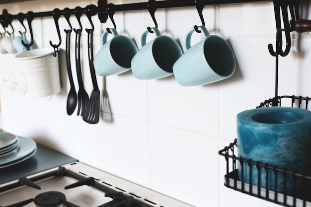 Interiors: pretty wall In the kitchen with some blue cups in a row