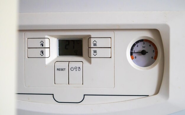 Internal control of a gas double-circuit boiler with a pressure\
and temperature sensor in the home heating system, close. energy\
saving and image efficient home concept. selective focus.