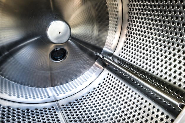 Internal view of laundry machines in laundromat.