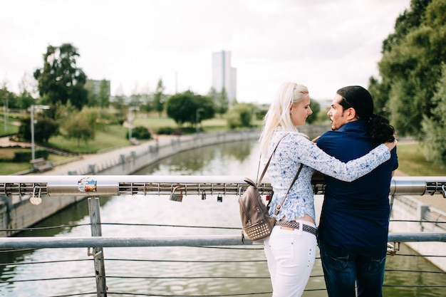 International couple hugs at nature