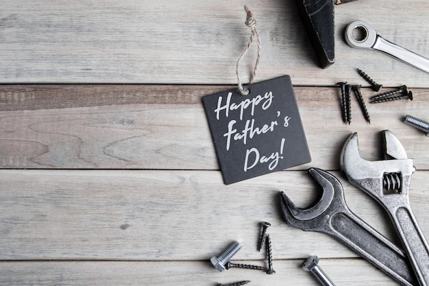 International fathers day greeting card work tools on a gray wooden background