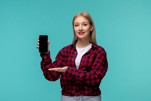 Photo international students day young cute girl in red checked shirt presenting a black phone