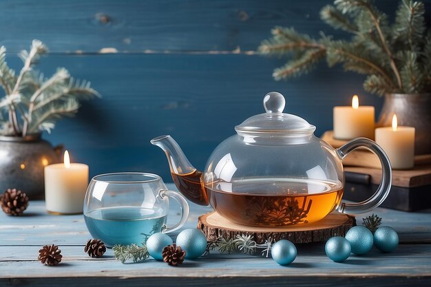 International tea day21 mayTransparent teapot and glass of tea in hand on faded blue wooden planks