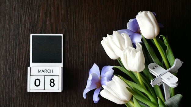 International Women39s Day is March 8 on the calendar Spring flowers tulips white and blue insert text