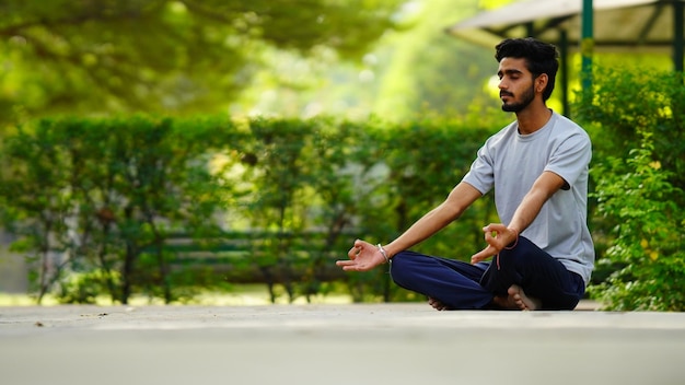 International yoga day image boy meditating in lotus position
at park