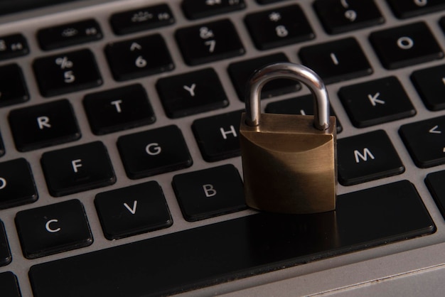 Internet and computer security represented by a closed padlock over a black keyboard