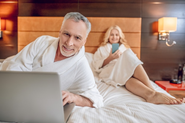 On internet. Couple in bath robes spending time online