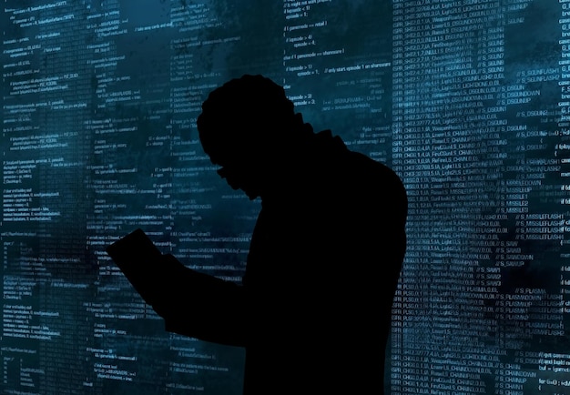 Internet crime concept Hacker working on code on dark digital background with round digital interface Hand typing data on keyboard seen on computer screen