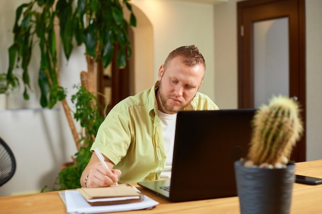 Internet for learning and job search Man hand making notes in notepad