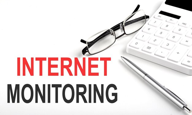 INTERNET MONITORING Concept Calculatorpen and glasses on white background